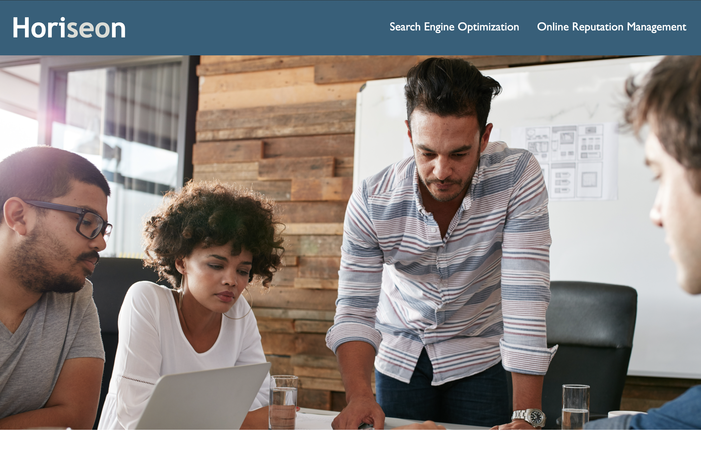A hero image screenshot of my refactor assignment. Professionals around a table at work.
